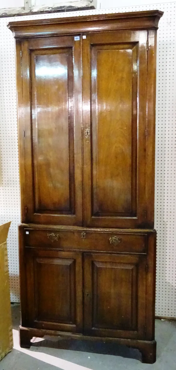 A mid-18th century mahogany double height corner cupboard, on bracket feet, 101cm wide x 125cm high.  M10