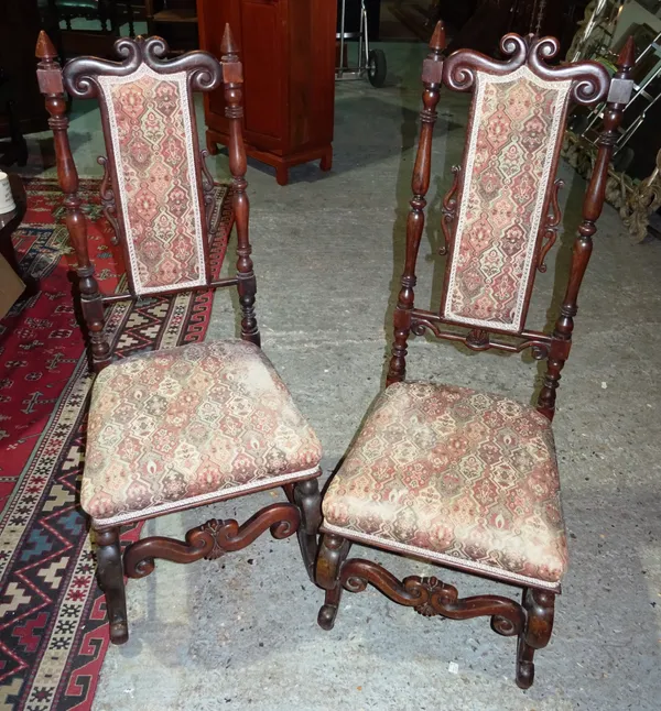 A pair of 17th century style mahogany hall chairs, each with scroll crest, on scroll supports, (2).  J3