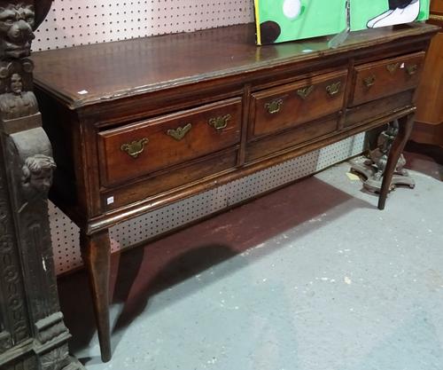 An 18th century oak dresser base, with three frieze drawers on cabriole supports, 155cm wide x 78cm high (lacking back legs).  C10