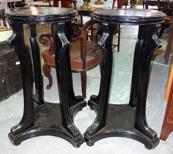 A pair of 20th century ebonised jardiniere stands, each on four downswept supports and a trefoil plinth base, 46cm wide x 94cm high, (2).  I8