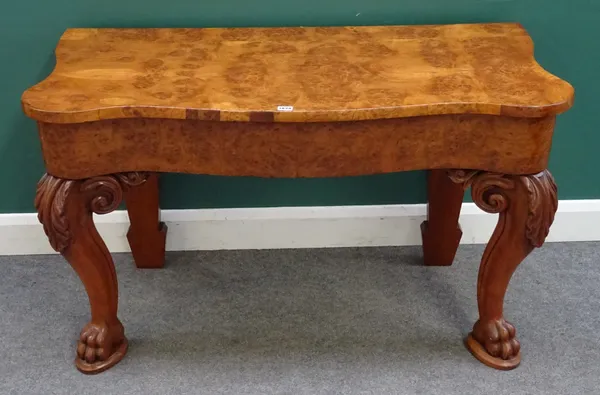 A 19th century pollard oak side table, the serpentine top with opposing end frieze drawers, on scroll supports and paw feet, 122cm wide x 55cm deep x