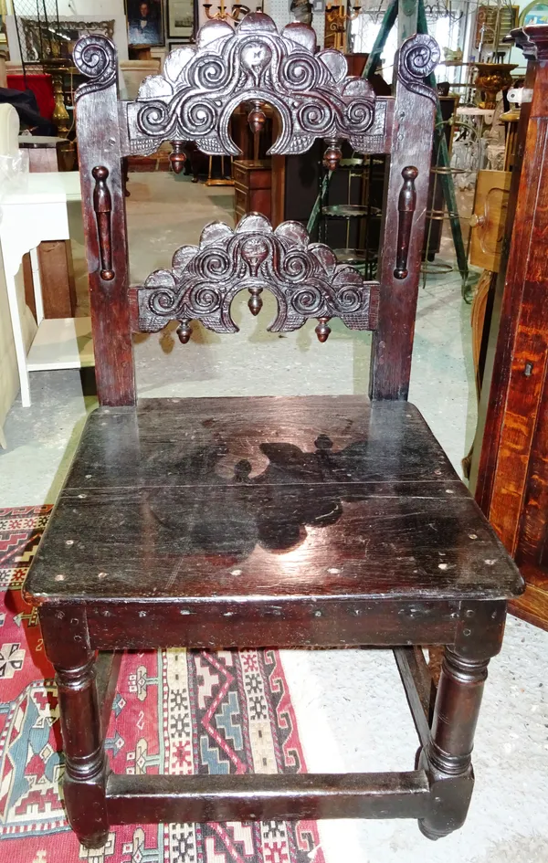 A 17th century and later oak Yorkshire chair, with carved back, on tapering block supports.  J4