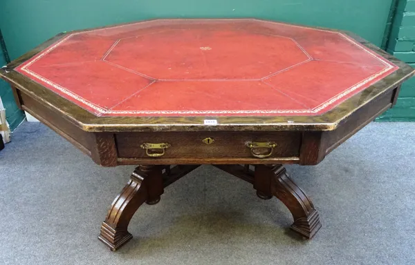 A late 19th century oak octagonal drum table, with gilt and leather inset top, on turned columns and four downswept supports, 162cm wide x 74cm high.
