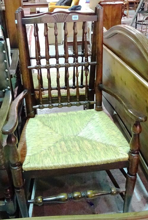 A pair of early 20th century oak spindle back open armchairs, (2).  J6