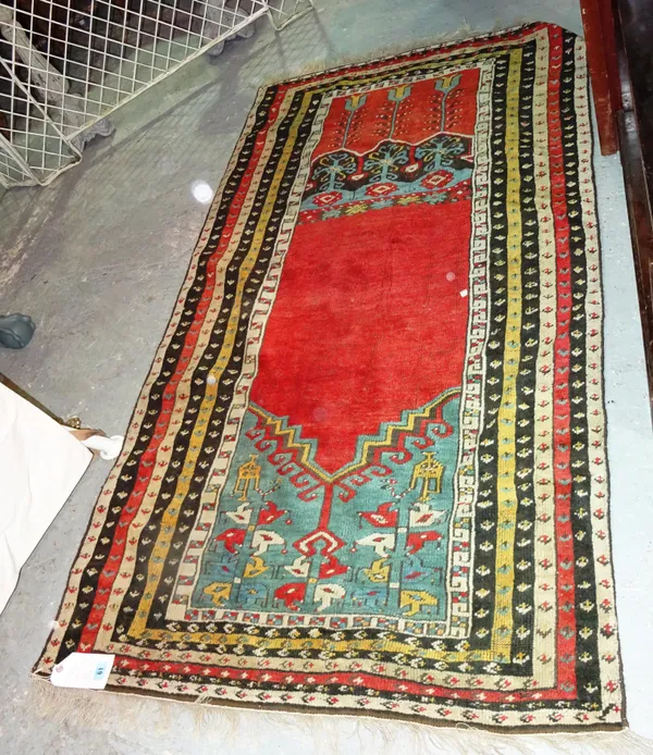 A Ladik prayer rug, the plain madder mihrab rising to a pale indigo arch, various minor borders, 190cm x 107cm.  C3