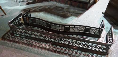 An early 20th century steel serpentine fire curb and another steel fire curb, (2).  H2