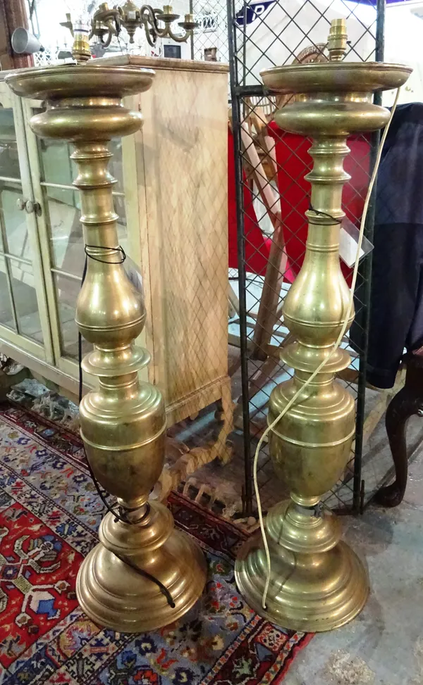 A pair of large 20th century brass altar type candlesticks, converted to lamps, 110cm high and a six light brass ceiling light, (3).  G4