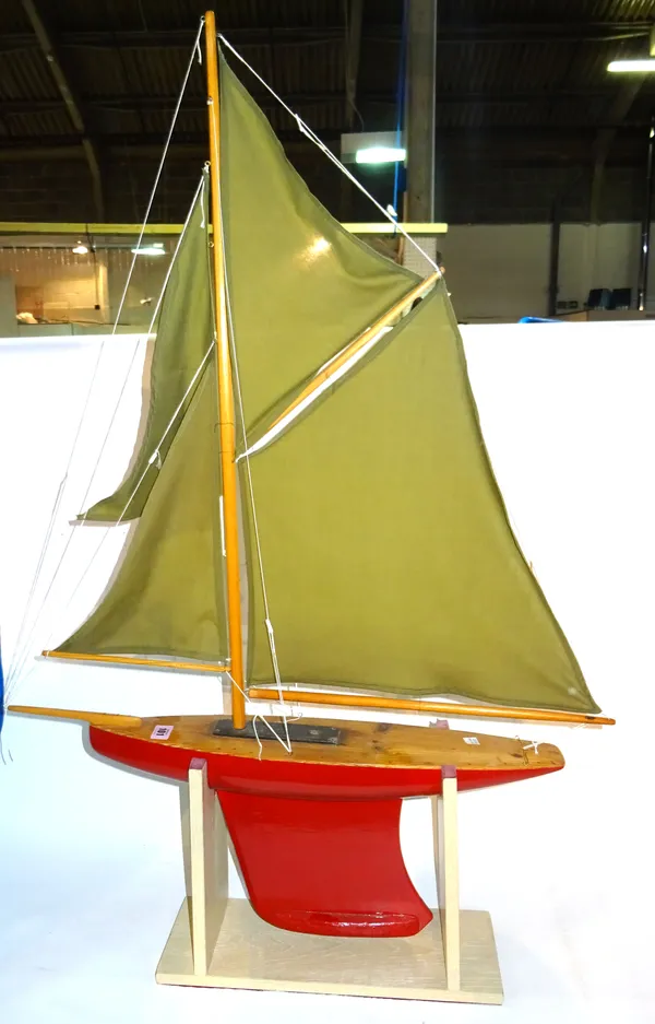 A 20th century scratch built pond yacht with red painted hull, 70cm long.   H5