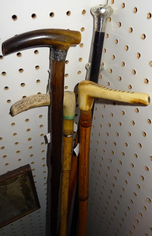 A group of five early 20th century walking canes, including one with silver pommel, (5).   CAB