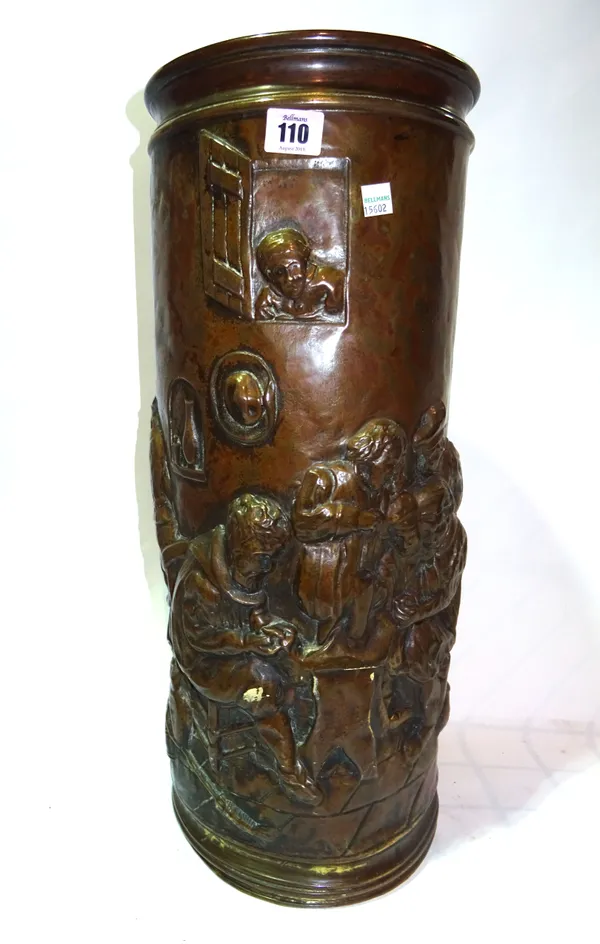 An early 20th century embossed copper cylindrical stick stand decorated with a tavern scene.  M8
