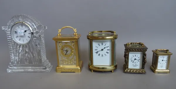 A French 'L Epee' miniature brass cased carriage clock (11cm high, key), a brass cased carriage clock of oval form (11.5cm high, key), a gilt metal mi