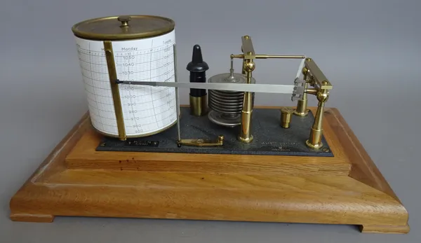 An oak cased aneroid barograph by Negretti and Zambra, on a plinth and four feet, 34.5cm wide.