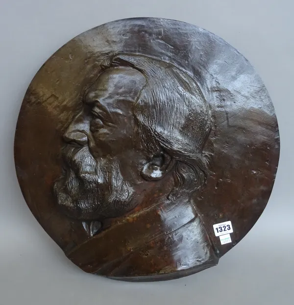 A Belgian bronze circular wall plaque, early 20th century, by Alphonse Joseph Strymans (Belgian, 1866-1959) relief cast with a bust of a bearded gentl