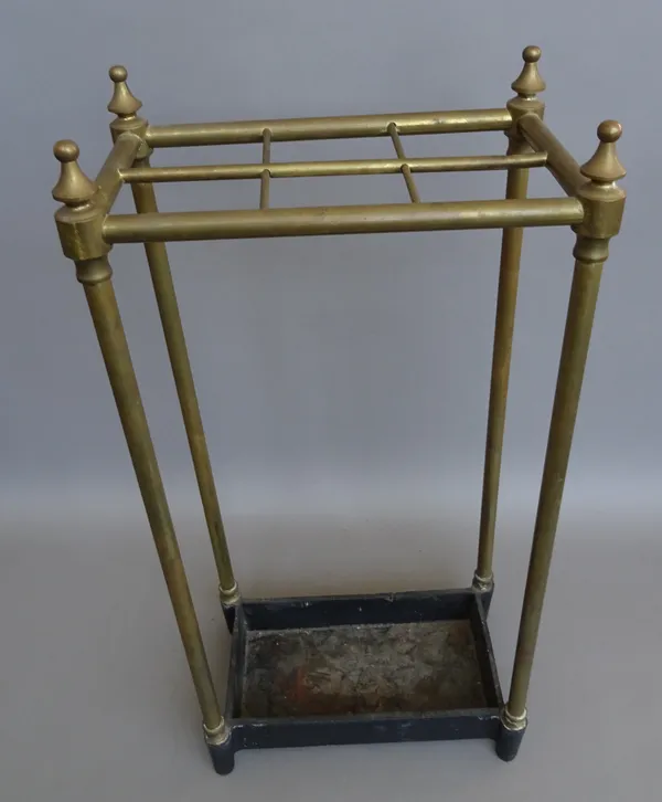 An Edwardian tubular brass six division stick stand on a rectangular cast iron base, 64cm high.