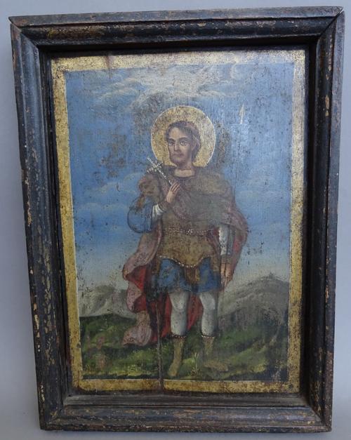 A North European Icon, possibly 17th century, depicting St Thomas holding a crucifix and lance, in a later ebonised wooden frame, panel, 26cm x 18cm.