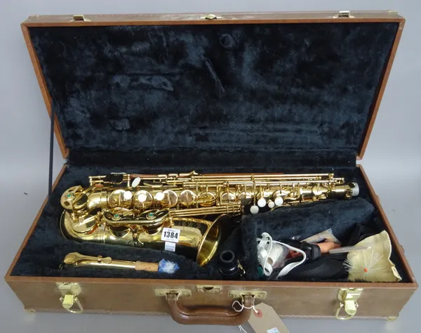 A modern Artemis MK11 brass saxophone, cased.