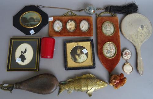 A group of small collectables including; an early 20th century brass reticulated fish (20cm), a leather shot dispenser, a silver hand mirror, a silhou