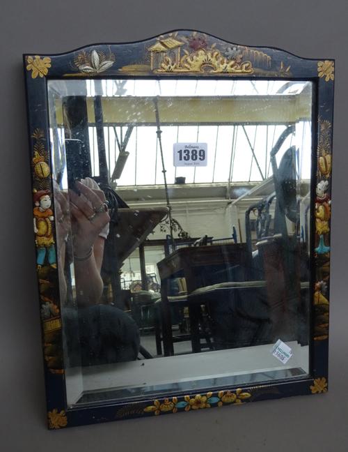 An early 20th century Chinoiserie decorated ebonised mirror with inset bevelled glass panel (36cm high), two smaller similarly decorated strut back ph