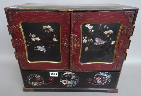 A Japanese mother-of-pearl inlaid lacquer table cabinet, circa. 1900, the hinged doors opening to reveal six small drawers (39cm wide), a Japanese mot