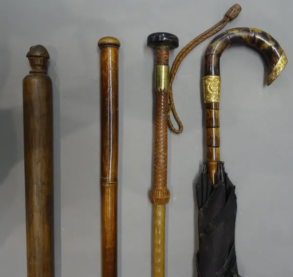 A bamboo 'harmonica' gadget cane, early 20th century, of naturalistic form (87cm), a miner's measure stick with figural finial (92cm), a brass and lea