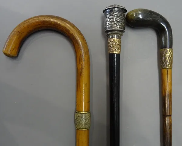 A shagreen mounted malacca walking stick (92cm), a 19th century horn mounted bamboo walking stick, with gilt metal collar (88cm) and a silver pomander