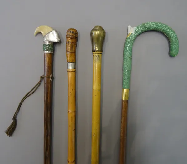 An early 20th century 'whistle' gadget cane with brass screw top pommel (88cm), a shagreen and leather bound walking stick with inset 'gadget' pen to