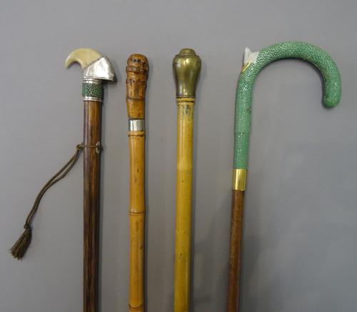 An early 20th century 'whistle' gadget cane with brass screw top pommel (88cm), a shagreen and leather bound walking stick with inset 'gadget' pen to