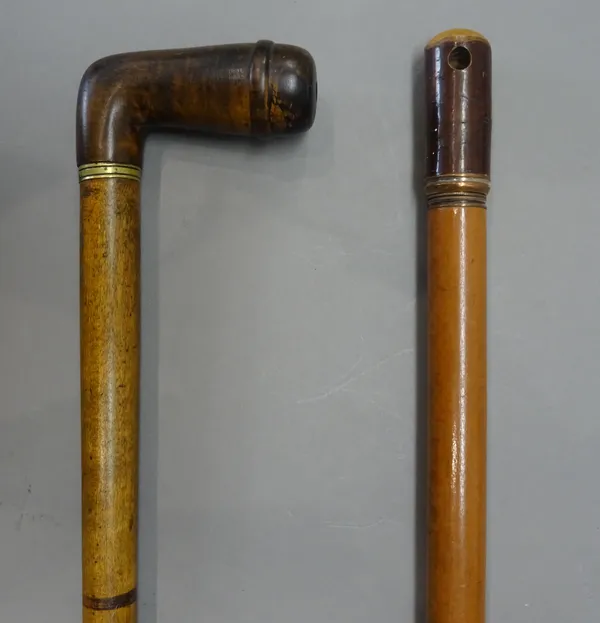 A carved wooden 'pipe' gadget walking stick, early 20th century, with pipe bowl handle and a concealed mouthpiece (87cm) and one further 'pipe' gadget