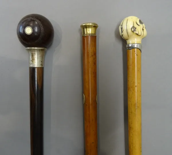 A rosewood, ivory and silver mounted walking cane, circa 1900, the pommel carved as a bowls ball, with an indistinctly hallmarked silver collar (91.5c
