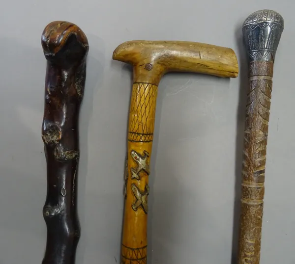 An Irish Shillelagh black thorn walking stick, with silver presentation plaque, dated 1894 (86cm), another carved wooden walking stick commemorating T