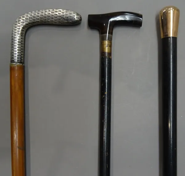 A 9ct gold mounted ebonised walking cane with indistinct hallmarks, circa 1890 (89cm), a silver topped walking cane with a basket weave 'putter' type