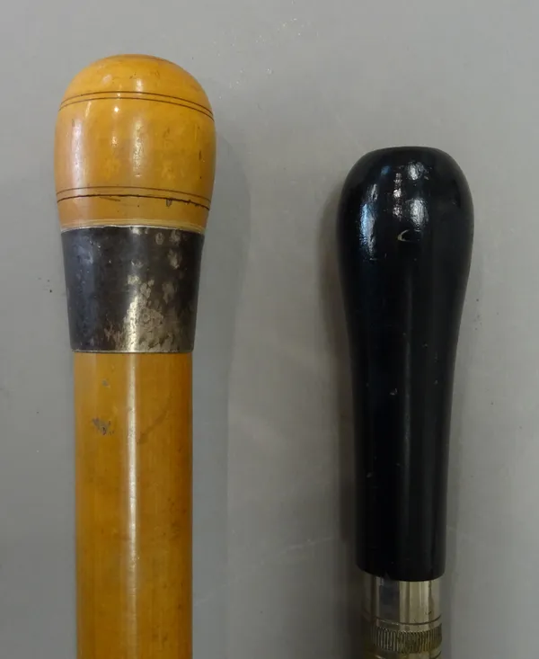 A large malacca gadget walking cane, late 19th century, the screw top pommel enclosing two bone dice (97cm) and an ebonised gadget cane with torch han