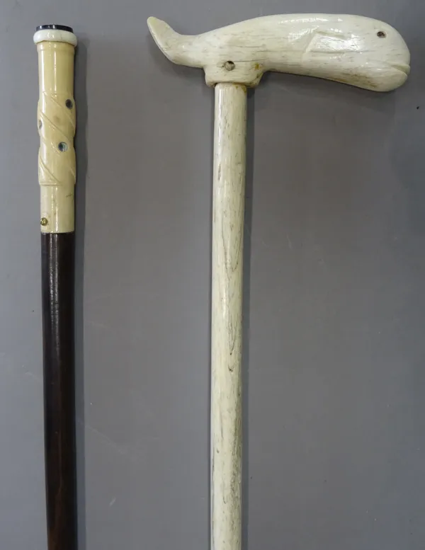 A Victorian whalebone walking stick, the handle caved as a whale (95cm) and an ivory and mother of pearl inlaid hardwood walking cane, early 20th cent