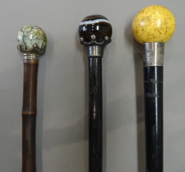 A Victorian ivory and silver mounted walking cane, with spherical pommel and silver collar hallmarked London 1896 over an ebonised tapering shaft (91.