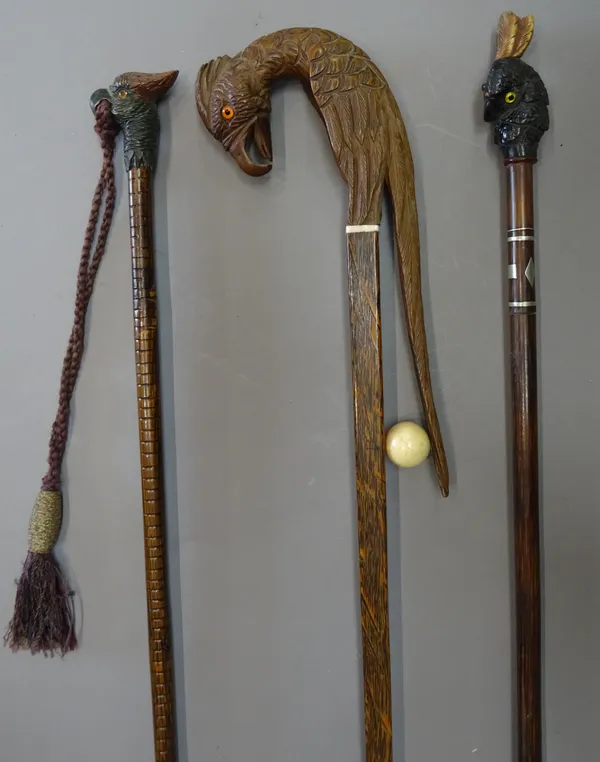An unusual African ivory mounted walking stick, 19th century and later, the handle carved as a parrot over a tapering square shaft (95cm) and two furt