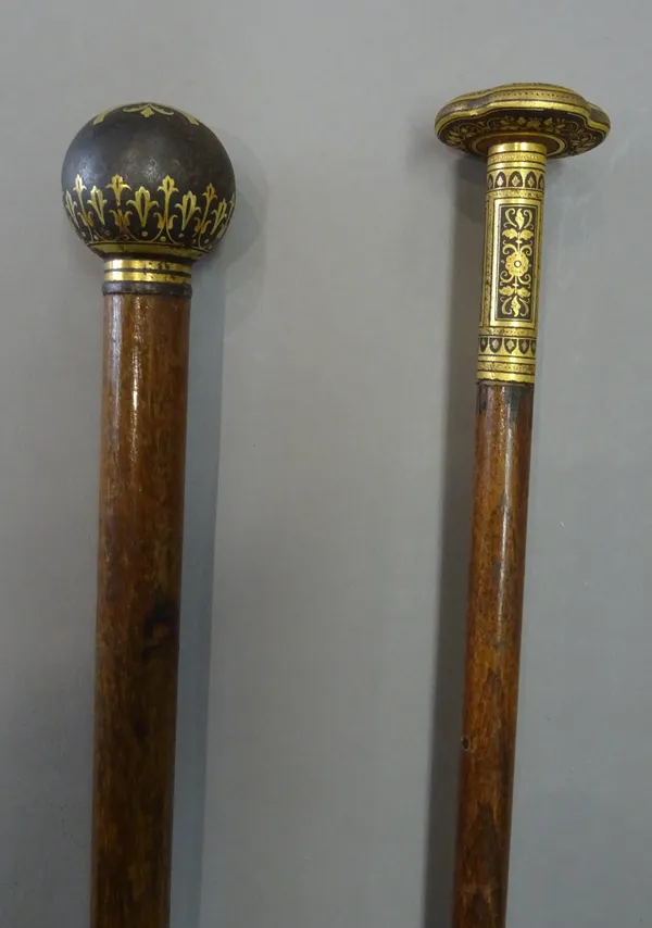 A Damascene Toledo gilt metal mounted ebonised walking cane, circa 1900, with quadrilobe shaped handle, detailed with gilt foliate engraving (95cm) an