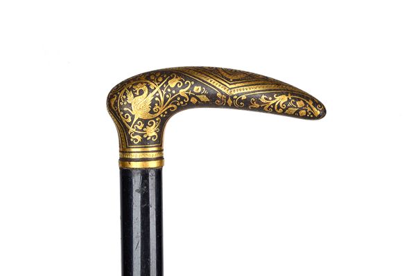 A Damascene Toledo gilt metal mounted ebonised walking stick, circa 1900 with foliate detail to the handle (88.5cm) and another with tapering cylindri