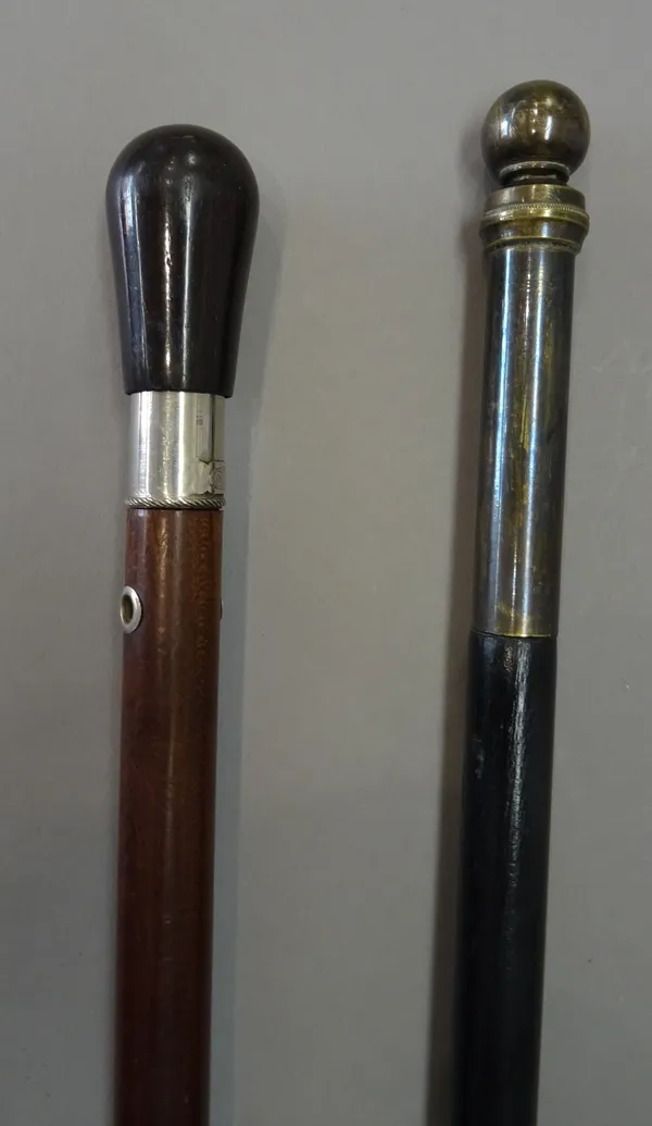 A brass and ebonised 'lamp lighters' gadget cane, 19th century, with spherical screw cap pommel, enclosing a petrol reservoir and wick (111cm) and a F