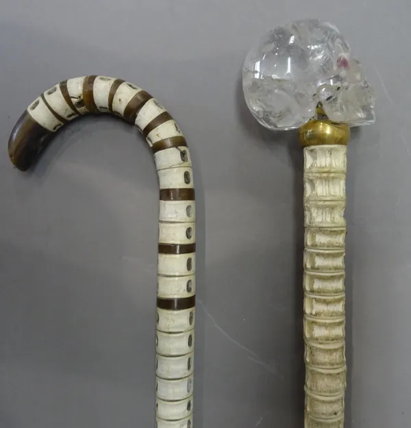 A Victorian shark vertebrae walking stick with horn inclusions (88cm) and a modern shark vertebrae walking cane with a carved rock crystal 'skull' pom
