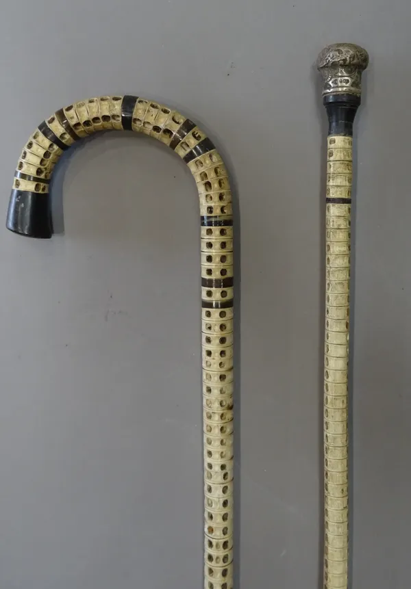 A Victorian shark vertebrae walking stick, with horn inclusions (88.5cm) and a Victorian silver topped shark vertebrae walking cane (90cm), (2).