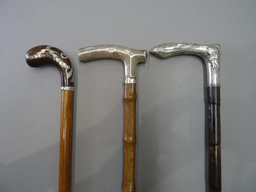 A Continental silver and bamboo Art Nouveau walking stick embossed with the head of a lady (86cm) another silver and bamboo walking stick hallmarked L