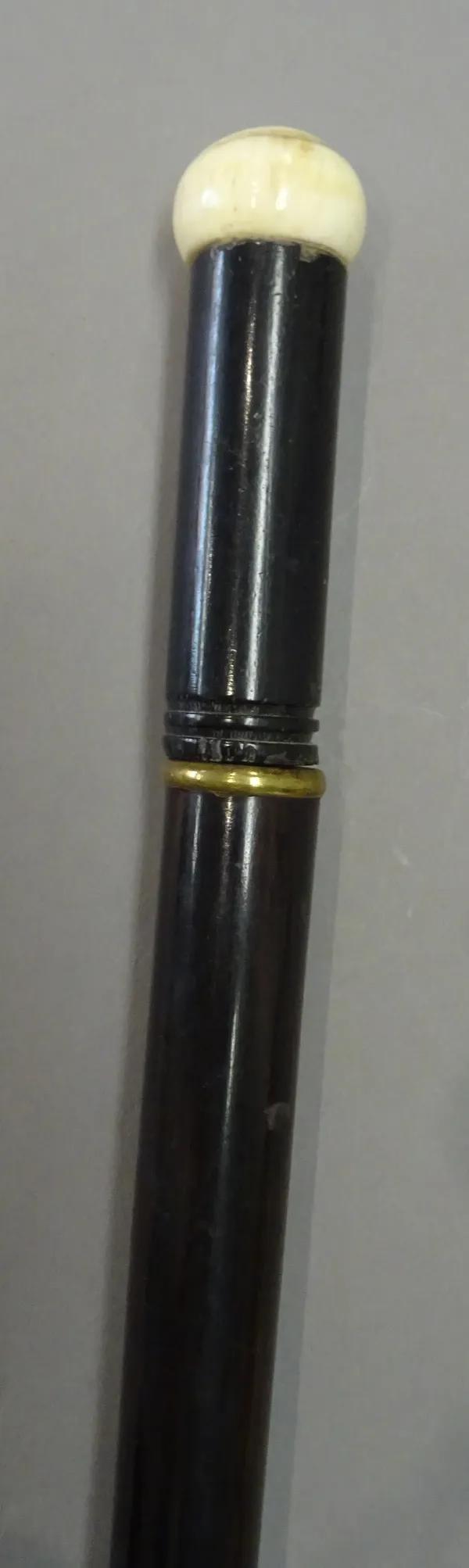 A rosewood, ebony and ivory mounted 'flute' walking cane, early 20th century, of sectional tapering form stamped 'H. POTTER & CO LONDON' 95.5cm.