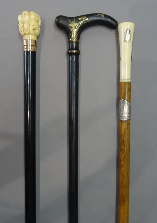 A Japanese Shibayama walking cane, circa 1900, a Japanese ivory and gold mounted walking cane, the pommel carved with Buddha faces, the gold collar ha