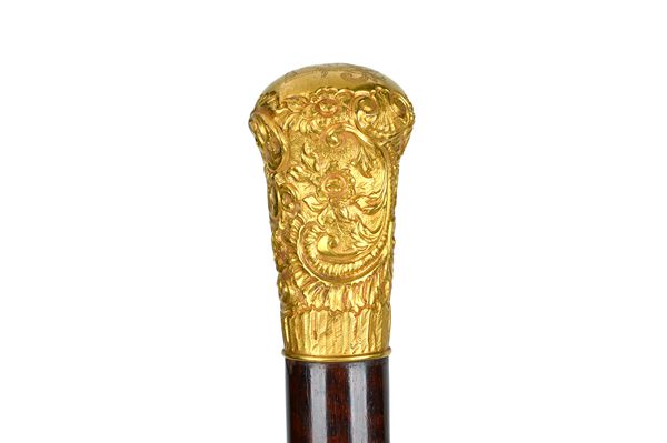 A Continental gold mounted snakewood walking cane, late 19th century, the gold foliate embossed pommel with engraved monogram to the top, 92cm. Illust