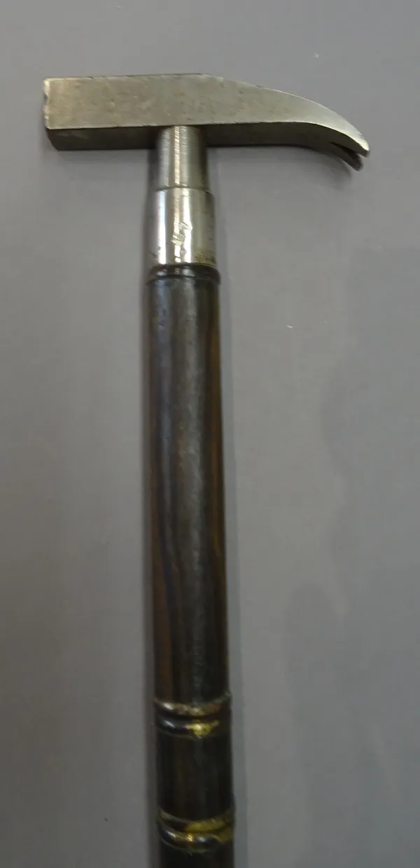 A steel mounted wooden gadget cane, early 20th century, the handle formed as a hammer head, unscrewing to reveal a screwdriver, glass cutter, drill bi