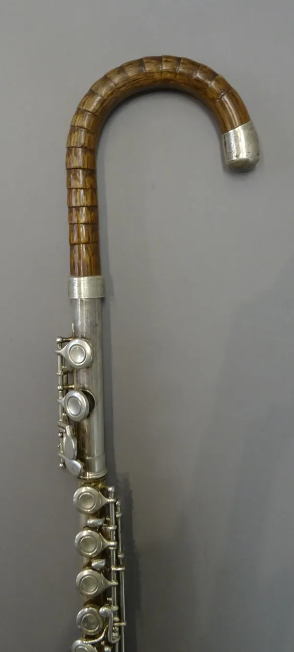 A novelty 'flute' walking stick, with bamboo handle and white metal mounts, 96cm.