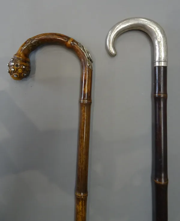 A bamboo and silver mounted 'horse measure' walking stick, 19th century, stamped 'ARNOLD & SONS LONDON' (93cm) and another similar with silver handle,
