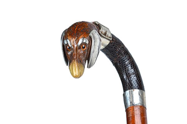 A Black Forest walking stick, circa 1900, with carved dog's head pommel, horn nose/mouth and white metal mounts, with a snake skin handle and bamboo s