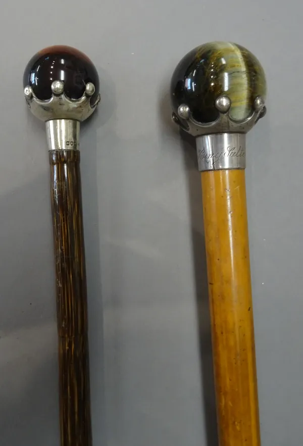 A hardstone and silver mounted walking cane with spherical 'tiger's eye' pommel and crown silver mount, hallmarked London 1889, (85cm) and another sim