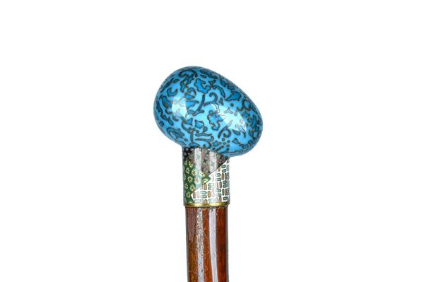 A cloisonné enamel hardwood walking cane, circa 1900, with egg form pommel (89cm) and one further walking cane, with cloisonné pommel, (86.5cm), (2).